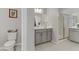 Bathroom with single vanity, toilet, and shower with glass door at 8729 Marcana St, Las Vegas, NV 89166