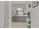 Bathroom with double vanity, framed mirror, and neutral wall paint at 8729 Marcana St, Las Vegas, NV 89166