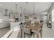 Stylish dining area adjacent to a sleek, well-equipped kitchen, ideal for entertaining at 8729 Marcana St, Las Vegas, NV 89166
