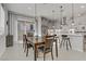 Open-concept dining area connected to a modern kitchen, perfect for gatherings at 8729 Marcana St, Las Vegas, NV 89166