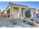 Inviting front porch with stone accents and a well-manicured yard offers great curb appeal at 8729 Marcana St, Las Vegas, NV 89166