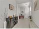 Open hallway featuring tile flooring, a bench, and decorative artwork on the walls at 8729 Marcana St, Las Vegas, NV 89166