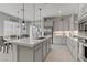 Open kitchen featuring an island with sink, stainless appliances, modern cabinets and lots of natural light at 8729 Marcana St, Las Vegas, NV 89166
