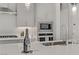 Kitchen island features a modern faucet, undermount sink, sleek countertops, and stainless steel appliances at 8729 Marcana St, Las Vegas, NV 89166