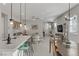 Spacious kitchen island connects to the living room, featuring pendant lights and seating, perfect for entertaining at 8729 Marcana St, Las Vegas, NV 89166