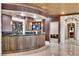 Entertaining bar area with custom cabinets, unique ceiling details and stone archway at 9103 Alta Dr # 1502, Las Vegas, NV 89145