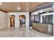 Entertaining bar area with stone archways, custom cabinets, and unique ceiling details at 9103 Alta Dr # 1502, Las Vegas, NV 89145