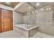 Spa-like bathroom with a soaking tub, glass-enclosed shower, and tasteful tile work, offering a serene retreat at 9103 Alta Dr # 1502, Las Vegas, NV 89145