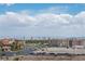 Striking view showcases the community's proximity to the city skyline with lush landscaping and blue sky at 9103 Alta Dr # 1502, Las Vegas, NV 89145