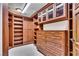Custom walk-in closet featuring wood cabinetry and ample storage space for organizing wardrobe items at 9103 Alta Dr # 1502, Las Vegas, NV 89145