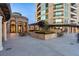 Elegant courtyard featuring stone architecture, manicured landscaping, and outdoor seating area at 9103 Alta Dr # 1502, Las Vegas, NV 89145