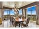 Beautiful dining area with city skyline views, complemented by a grand chandelier and luxurious finishes at 9103 Alta Dr # 1502, Las Vegas, NV 89145