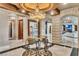 Elegant foyer features a chandelier, marble floors, and stone archways leading to the living space at 9103 Alta Dr # 1502, Las Vegas, NV 89145