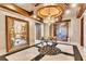 Elegant foyer features a chandelier, marble floors, and a decorative table below the ceiling medallion at 9103 Alta Dr # 1502, Las Vegas, NV 89145