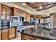 Gourmet kitchen featuring stainless steel appliances, black countertops, and custom cabinets at 9103 Alta Dr # 1502, Las Vegas, NV 89145