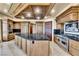 Gourmet kitchen features a central island, stainless steel appliances, and custom cabinetry at 9103 Alta Dr # 1502, Las Vegas, NV 89145