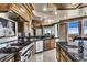 Gourmet kitchen featuring stainless steel appliances, black countertops, and island sink at 9103 Alta Dr # 1502, Las Vegas, NV 89145