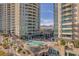 Elevated pool area with desert views, lounge chairs, and mature landscaping at 9103 Alta Dr # 1502, Las Vegas, NV 89145