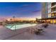 Upscale swimming pool featuring tiled deck, multiple lounge chairs and views of desert landscape at 9103 Alta Dr # 1502, Las Vegas, NV 89145