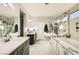 This bathroom offers a soaking tub, double sinks, and luxurious tile at 9765 Skye Star Ave, Las Vegas, NV 89166