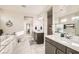 This bathroom includes double sinks, a separate bathtub, and sleek tile at 9765 Skye Star Ave, Las Vegas, NV 89166