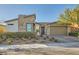 Charming single-story home featuring stone accents, desert landscaping, and an attached two-car garage at 9765 Skye Star Ave, Las Vegas, NV 89166