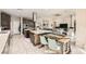 This open-concept kitchen offers an island, dining space, and stainless steel appliances at 9765 Skye Star Ave, Las Vegas, NV 89166