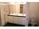 Bathroom featuring dual sinks, tile flooring, and shower with glass door at 102 Harbor View Dr # 102, Boulder City, NV 89005