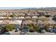 Wide aerial shot of a neighborhood featuring similar houses and mountain view at 10608 Medicine Bow St, Las Vegas, NV 89183