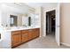 Bathroom showcasing double sinks, a large mirror, and doorway view at 10608 Medicine Bow St, Las Vegas, NV 89183