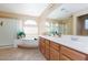 Bright bathroom with a step-up tub, double sinks, and a glass shower enclosure at 10608 Medicine Bow St, Las Vegas, NV 89183