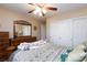 Comfortable bedroom with ceiling fan, dresser, closet and patterned bedding at 10608 Medicine Bow St, Las Vegas, NV 89183
