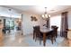Dining area with marble table set for four and with a view to the kitchen and back yard at 10608 Medicine Bow St, Las Vegas, NV 89183