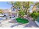 Beautifully landscaped front yard with mature trees and a well-maintained lawn at 10608 Medicine Bow St, Las Vegas, NV 89183
