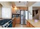Kitchen featuring stainless steel appliances, a gas stove, and wooden cabinets with tan countertops at 10608 Medicine Bow St, Las Vegas, NV 89183