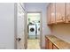 Bright laundry room featuring cabinetry, folding counter, and modern washer and dryer units at 10608 Medicine Bow St, Las Vegas, NV 89183