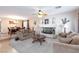 Inviting living room featuring neutral colored walls and carpet, ceiling fan, and fireplace at 10608 Medicine Bow St, Las Vegas, NV 89183