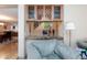 Cozy living room featuring a bar area with cabinetry and a view of the staircase at 10608 Medicine Bow St, Las Vegas, NV 89183