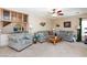 Living room featuring comfortable seating, a ceiling fan, and a dry bar with wine rack at 10608 Medicine Bow St, Las Vegas, NV 89183