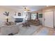 Cozy living room featuring a fireplace, ceiling fan, carpet, and a view to the entry at 10608 Medicine Bow St, Las Vegas, NV 89183
