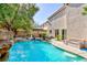 Inviting backyard pool and spa area with lush landscaping, and lounging area at 10608 Medicine Bow St, Las Vegas, NV 89183