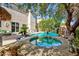 Stunning backyard with pool, spa, lush landscaping, and covered seating area at 10608 Medicine Bow St, Las Vegas, NV 89183
