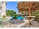 Relaxing poolside patio with comfortable seating and a shaded tiki bar at 10608 Medicine Bow St, Las Vegas, NV 89183