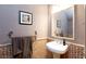 Charming powder room featuring a pedestal sink, decorative mirror, and mosaic tile accents at 10608 Medicine Bow St, Las Vegas, NV 89183