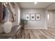 Bright entryway featuring modern art, plants, and wood-look floors at 1534 Shady Elm St, Las Vegas, NV 89135