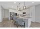 Stylish kitchen featuring a center island with seating, granite countertops, and stainless steel appliances at 169 Volti Subito Way, Henderson, NV 89011