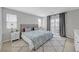 Serene main bedroom with a plush rug, queen-sized bed and patio access through sliding glass doors at 169 Volti Subito Way, Henderson, NV 89011