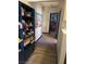 Hallway with colorful patterned rug, bookcase, and light wood-look flooring at 1712 Sweeney Ave, Las Vegas, NV 89104