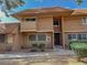 Two-story condo featuring a small balcony, neutral exterior paint, desert landscaping, and a sidewalk at 2506 Paradise Village Way, Las Vegas, NV 89120