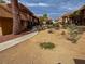 Desert landscaped condo community view featuring mature trees, sidewalks and neutral color paint at 2506 Paradise Village Way, Las Vegas, NV 89120